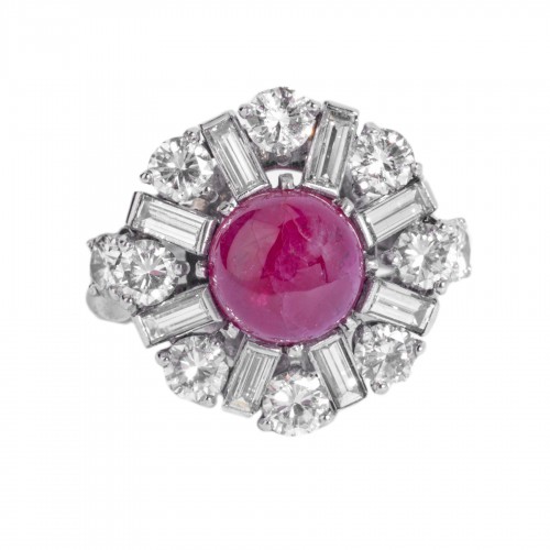 Platinum ring set in its center with a cabochon ruby and diamonds