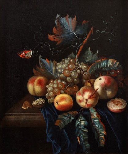 A still life with fruits on a table ledge with a butterfly - German School 