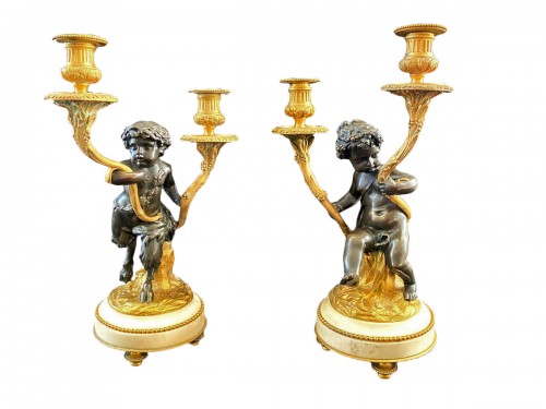 Pair of bronze candelabras with cherubs