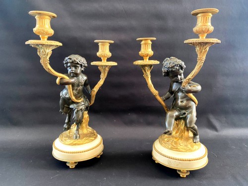 Lighting  - Pair of bronze candelabras with cherubs