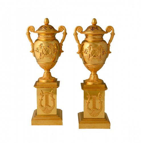 A pair of French Empire ormolu cassolettes