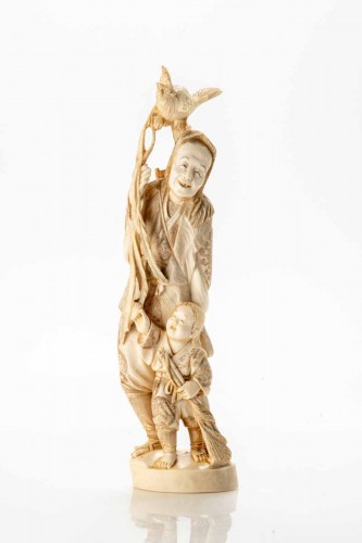 Asian Works of Art  - A Japanese ivory okimono depicting a hunter with an Onagadori rooster