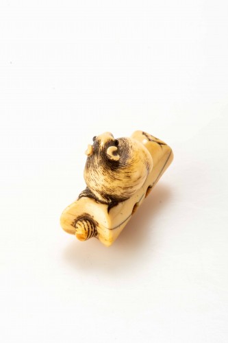 Asian Works of Art  - An Ivory Netsuke Depicting A Mouse Crouching On An Overturned Candle