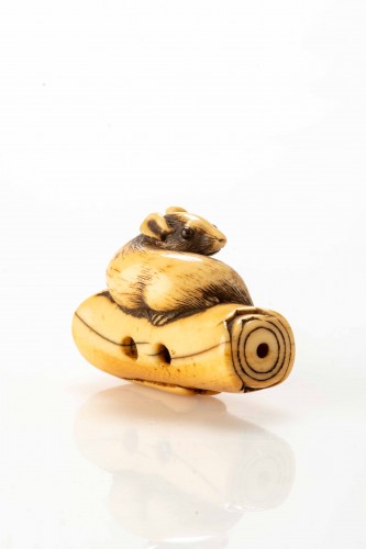 An Ivory Netsuke Depicting A Mouse Crouching On An Overturned Candle - 