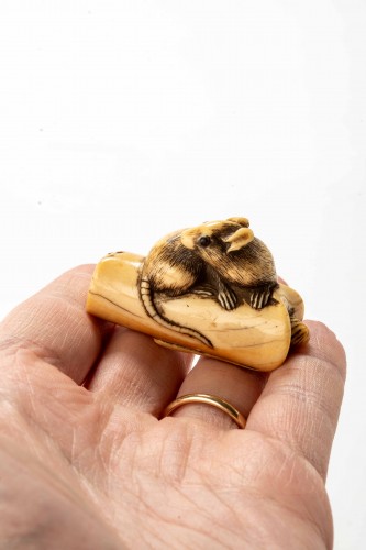  - An Ivory Netsuke Depicting A Mouse Crouching On An Overturned Candle