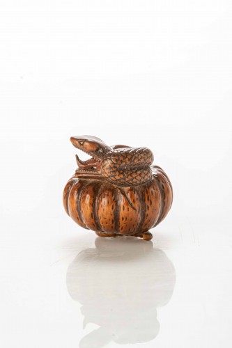Asian Works of Art  - A Boxwood Netsuke Depicting A Snake Wrapping Around A Pumpkin