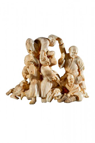 An Ivory Okimono With Blind Travelers Defending Themselves From An Attack