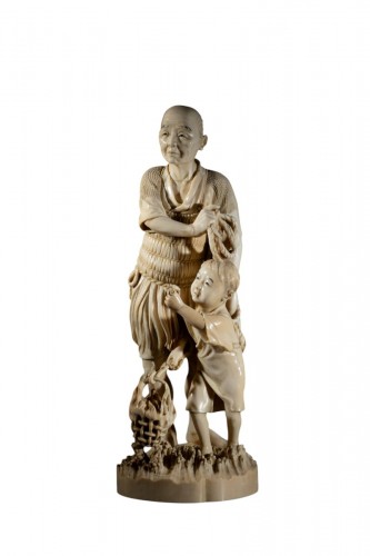 A Tokyo School Ivory Okimono Depicting A Fisherman With A Child