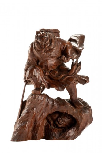 A Boxwood Okimono Depicting Shoki Attempting To Surprise An Oni