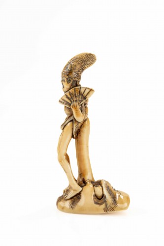 A shunga ivory netsuke depicting a monk seated on the nose of Tengu - 