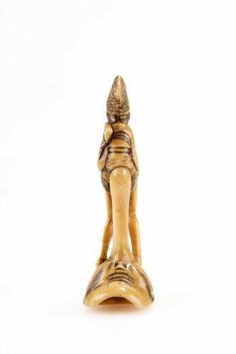 19th century - A shunga ivory netsuke depicting a monk seated on the nose of Tengu