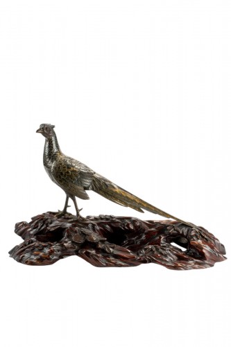 A japanese gilt and patinated bronze okimono of a pheasant
