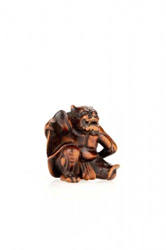 Asian Works of Art  - A boxwood netsuke depicting an Oni and the Setsubun festival