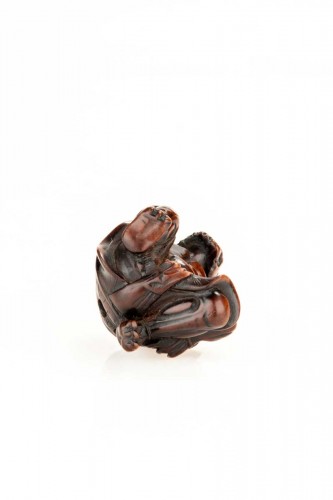 A boxwood netsuke depicting an Oni and the Setsubun festival - 