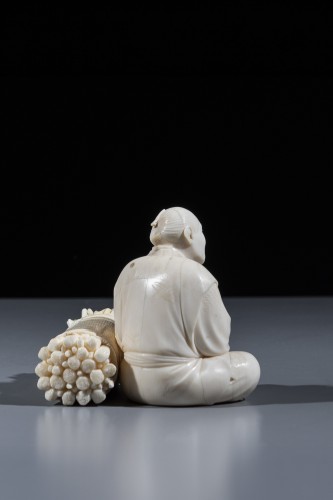 Asian Works of Art  - An ivory okimono depicting a woodcutter 