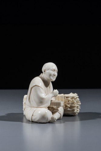 An ivory okimono depicting a woodcutter  - 