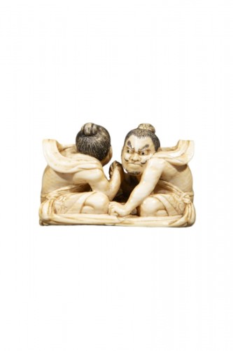 An ivory netsuke depicting Raijin and Fujin on a sandal
