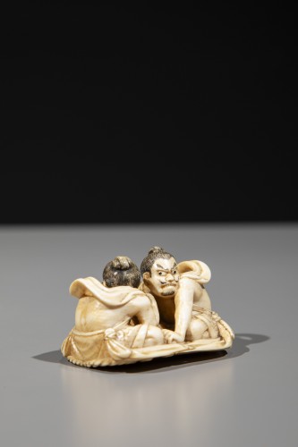 Asian Works of Art  - An ivory netsuke depicting Raijin and Fujin on a sandal
