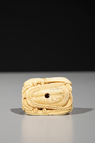 An ivory netsuke depicting Raijin and Fujin on a sandal - 