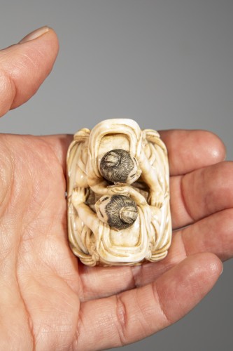 An ivory netsuke depicting Raijin and Fujin on a sandal - 