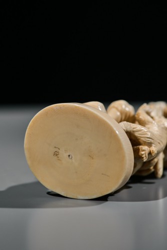  - An ivory okimono of Kintaro with a phoenix, signed Kazutoshi