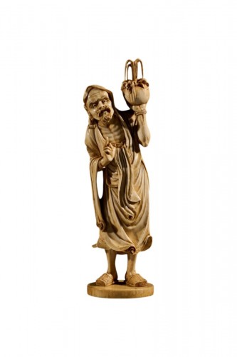 An Ivory Okimono Of A Rakan Holding A Ritual Vase, Signed Kazutoshi
