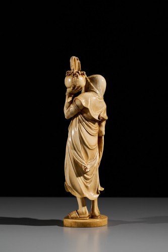 An Ivory Okimono Of A Rakan Holding A Ritual Vase, Signed Kazutoshi - 