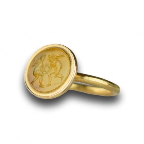  - Gold ring with a Roman intaglio of wrestling Erotes. 1st - 2nd century AD. 