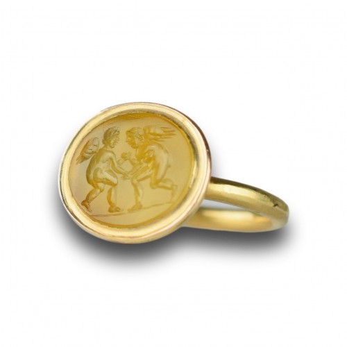 Antiquités - Gold ring with a Roman intaglio of wrestling Erotes. 1st - 2nd century AD. 