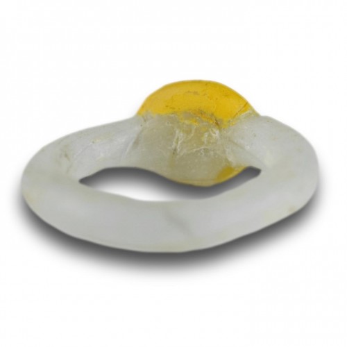 BC to 10th century - White glass ring with a yellow bezel and amber bead. Roman, 2nd-3rd Century