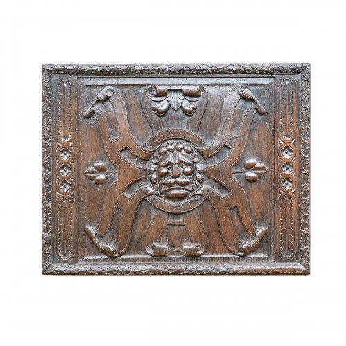 Large walnut panel carved with the head of a lion