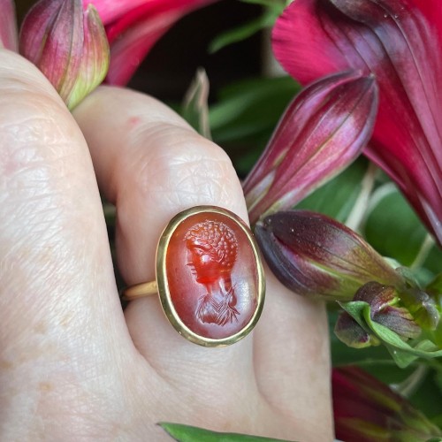  - Gold ring set with an carnelian intaglio of a male portrait bust.