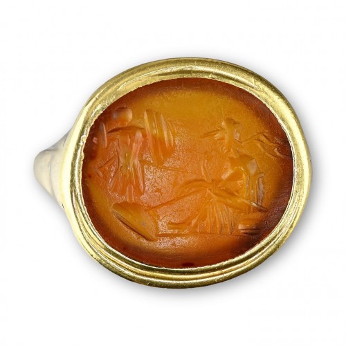 Gold ring with a Roman intaglio of a seated Minerva before a trophy of armo - 