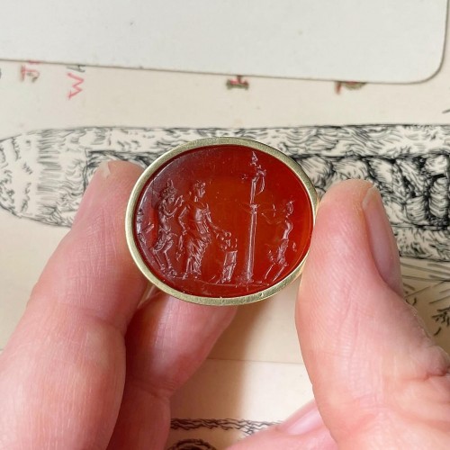 Carnelian intaglio of a Bacchanalian sacrifice set into a gold ring. - 