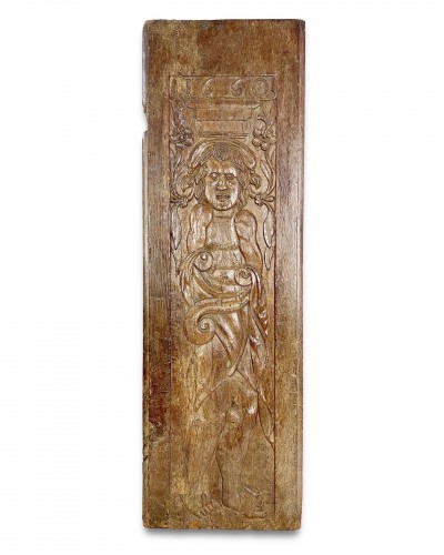 A large oak relief of a grotesque figure. French, dated 1660.