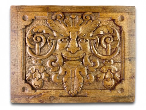 Pair of walnut panels carved with mascarons. French, late 16th century.