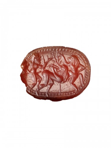 Cornelian scarab carved with frolicking Satyrs. Greek, Archaic period, c. 5