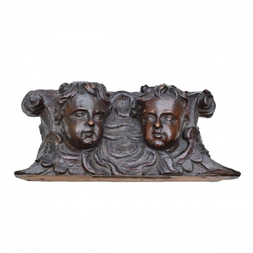 Oak relief of winged putti heads. English 18th century