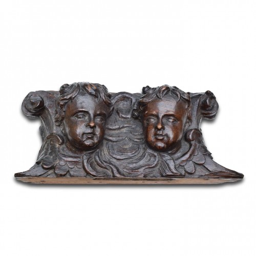  - Oak relief of winged putti heads. English 18th century