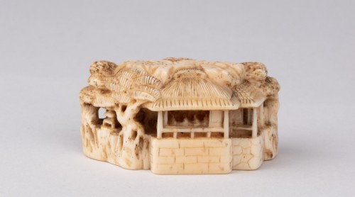 Asian Works of Art  - Netsuke  by Masatoshi; A ivory model showing a chinese landscape, Japan Edo