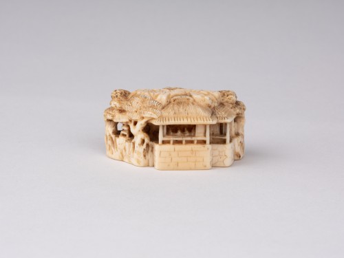 Netsuke  by Masatoshi; A ivory model showing a chinese landscape, Japan Edo - 