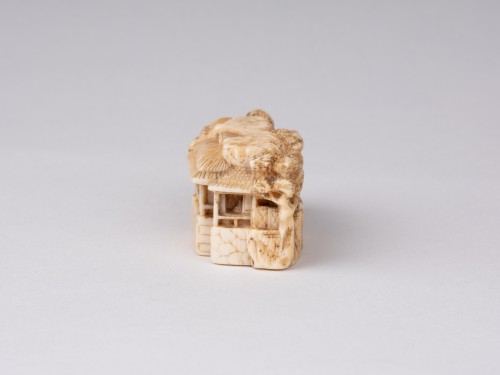  - Netsuke  by Masatoshi; A ivory model showing a chinese landscape, Japan Edo