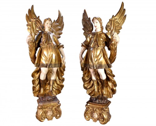 Large pair of torchiere angels in gilded wood,