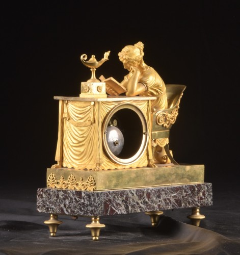 Horology  - La Lectura, a French Empire mantel clock in gilt bronze, ca, 1800
