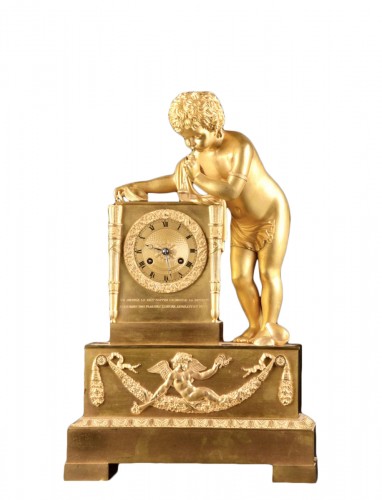 A French Louis Philippe mantel clock with a large putto, circa 1830