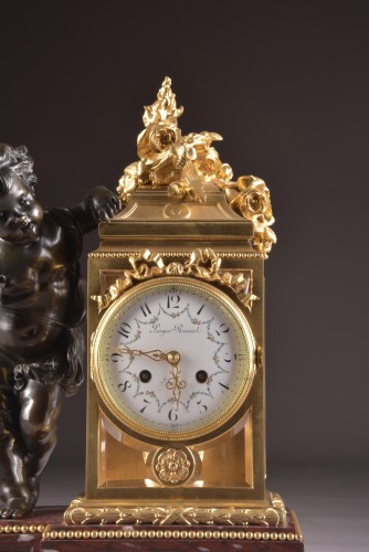 Horlogerie Pendule - Pendule Napoléon III en bronze doré et bronze patiné à putto
