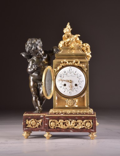 A Napoleon III ormolu and patinated bronze mantel clock with putto  - 