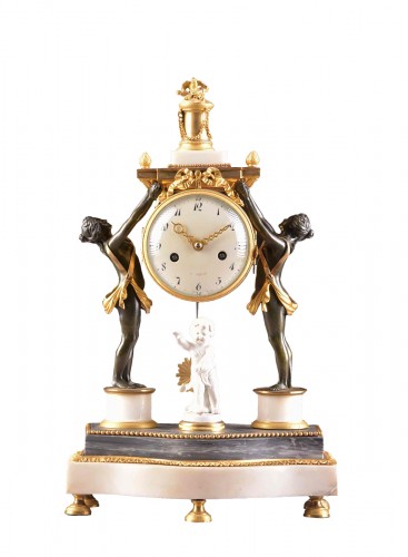 A louis xvi patinated bronze figural mantel clock