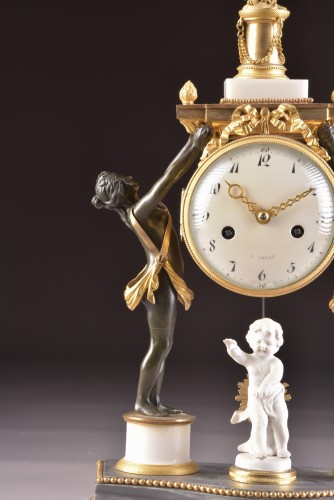 Horology  - A louis xvi patinated bronze figural mantel clock