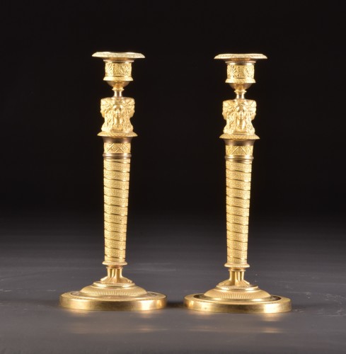 Antiquités - A pair of gilded bronze Empire candlesticks